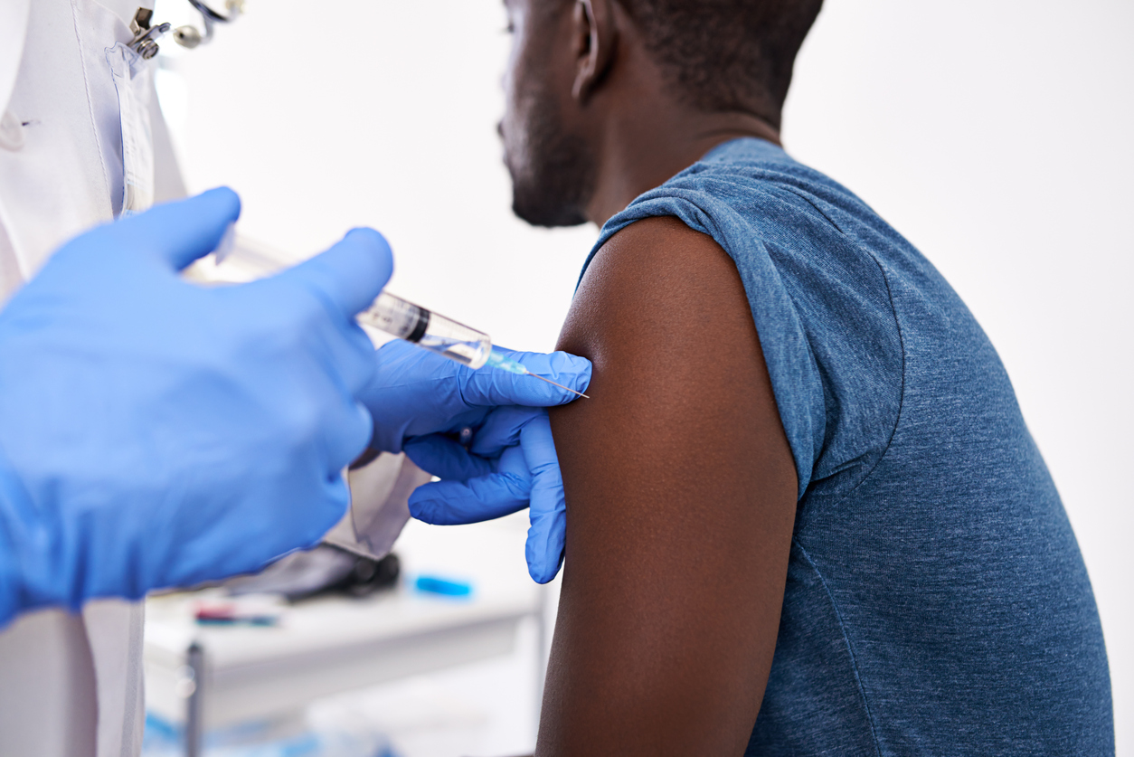 Cropped shot of a male patient getting an injection from a doctor